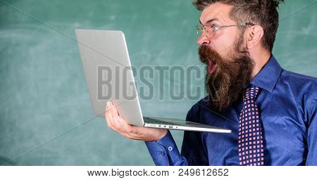 Shocking Information. Hipster Teacher Wear Eyeglasses And Necktie Holds Laptop Surfing Internet. Sho