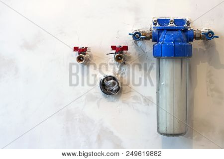 Water Filter New Installed On A Kitchen Wall To Purify Drinking Water.