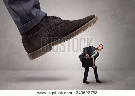 Young businessman illustrated inconsiderable by being trampled