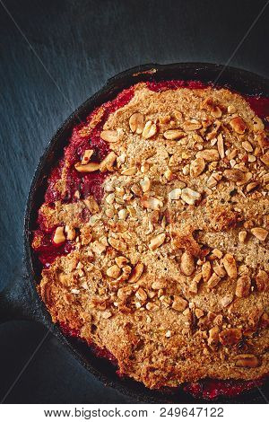 Summer Breakfast. Crumble With Blueberries In The Black Cast-iron Frying Pan On The Dark Stone Table