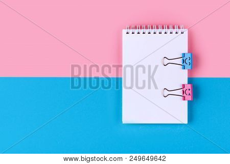 Top View Of Blank Notebook On Colorful Background Pink Blue With Copy Space.