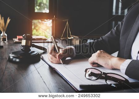 Advice And Justice Concept. Justice Scales And Justice Hammer And Female Lawyer Use Pen, Working Leg