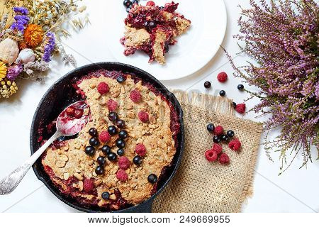 Summer Breakfast. Crumble With Blueberries In The Black Cast-iron Frying Pan On The White Table. Top