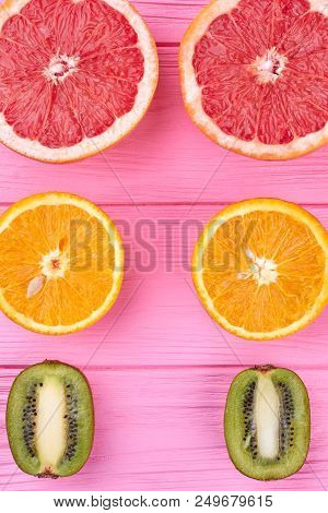 Fresh Juicy Citrus Fruits Wooden Background. Colorful Ripe Citrus Including Grapefruit, Orange And K