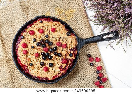Summer Breakfast. Crumble With Blueberries In The Black Cast-iron Frying Pan On The White Table. Top