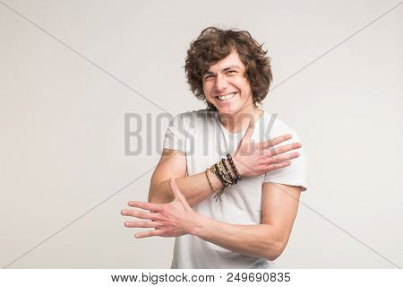 Portrait Of White Handsome Young Men Having Fun In White T-shirt With Stylish Bracelet