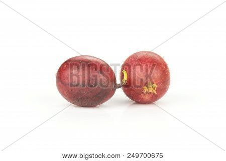 Group Of Two Whole Fresh Red Gooseberry Hinnomaki Variety Ripe Isolated On White