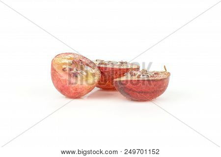 Group Of Three Halves Of Fresh Red Gooseberry Hinnomaki Variety Isolated On White
