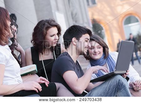 Group Of Fellow Students With Books And Laptop.education Concept