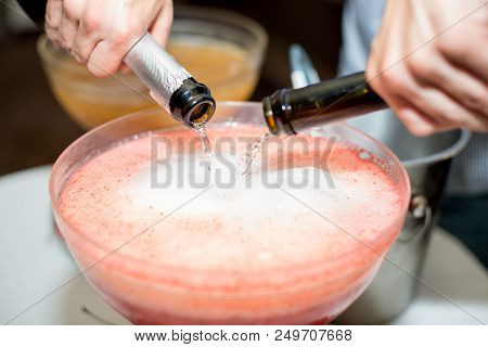 Beverage With Ice Cubes. Pouring Champagne. Mint And Fruit Are Out Of Focus