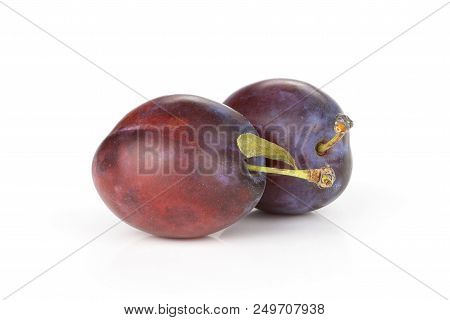 Group Of Two Whole Fresh Violet-blue Plum Vibrant Moyer Variety Isolated On White