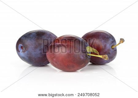 Group Of Three Whole Fresh Violet-blue Plum Vibrant Moyer Variety Stack Isolated On White