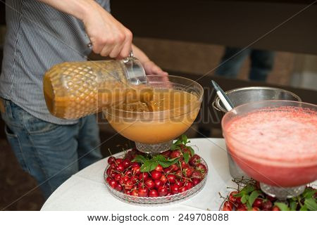 Beverage With Peach Ice Juice. Pouring Champagne. Mint And Fruit Are Out Of Focus