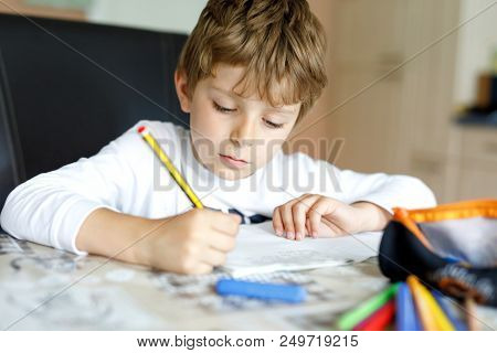 Tired Little Kid Boy At Home Making Homework At The Morning Before The School Starts. Little Child D