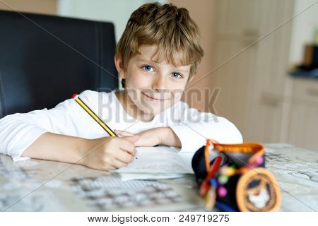 Tired Little Kid Boy At Home Making Homework At The Morning Before The School Starts. Little Child D
