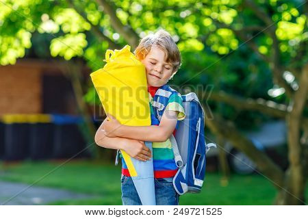 Happy Little Kid Boy In Colorful Shirt And Backpack Or Satchel And Traditional German School Bag Con