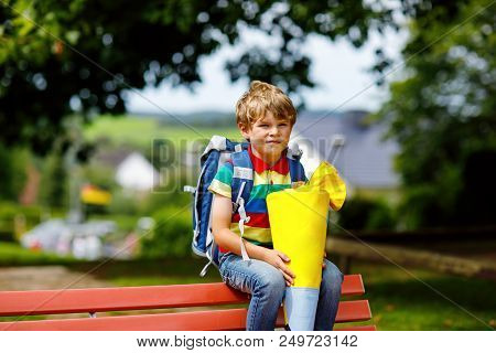 Happy Little Kid Boy In Colorful Shirt And Backpack Or Satchel And Traditional German School Bag Con