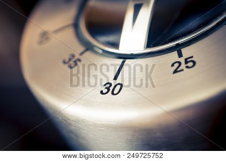 30 Minutes - A Macro Of An Analog Chrome Kitchen Timer With Dark Background