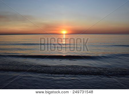 The Sun Casts Orange Shades Across An Evening Sky At Mindil Beach (darwin, Northern Territory, Austr