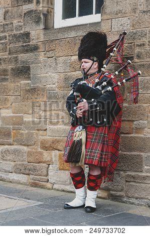 Edinburgh, Scotland - April 2018: A Scottish Piper Man Dressing In Scottish Traditional Tartan Kilt