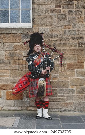 Edinburgh, Scotland - April 2018: A Scottish Piper Man Dressing In Scottish Traditional Tartan Kilt