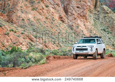 Moab , UT, USA - May 6, 2018:  Toyota 4runner SUV (2016 trail edition, stock vehicle without any off road modifacations)) on a desert canyon road.
