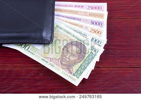 Malagasy Ariary In The Black Wallet On A Wooden Background