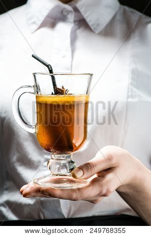 The Unidentified Waiter Holding A Glass With Hot Buttered Becherovka Cocktail