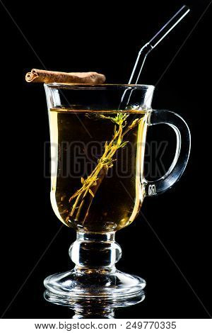 Hot Amaro Cocktail With Apple Juice And Cinnamon On Dark Background
