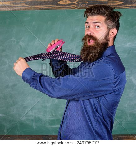 Hipster Teacher Formal Wear Necktie Holds Stapler. School Stationery. Man Scruffy Use Stapler Danger
