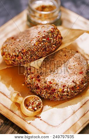 lamb burgers spiced by mint and lamb rub on wooded board
