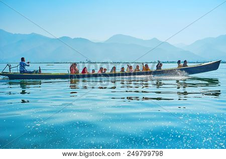 Inle Lake, Myanmar - February 18, 2018: The Smiling Tourists Waving The Hands, Sitting In Canoe Duri