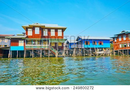 The Scenic Village On Inle Lake With Colored Timber Houses On Stilts And Narrow Canals In The Street