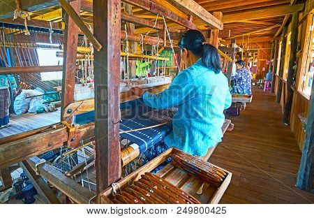 Inle Lake, Myanmar - February 18, 2018: The Burmese Artisan Weaves The Silk Fabric On The Hand Loom 