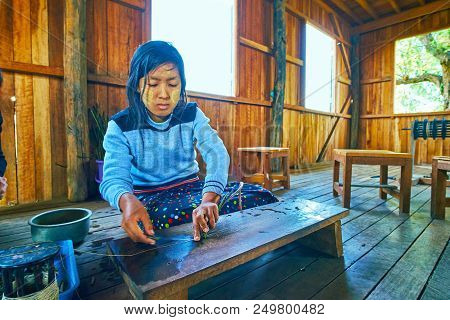 Inle Lake, Myanmar - February 18, 2018: The Young Worker Produce The Yarn From Green Stems Of Lotus 