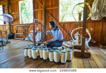 Inpawkhon, Myanmar - February 18, 2018: The Spools With Yarn In Front Of The Female Worker Of Hand W