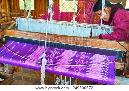 Inpawkhon, Myanmar - February 18, 2018: Production Of Silk Fabric - Burmese Woman At Job On Hand Loo
