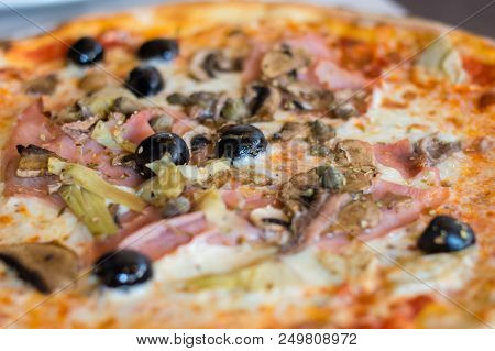 Close-up For Traditional Italian Pizza Capricciosa With Tomato Sauce, Mozzarella, Ham, Carciofi, Fun