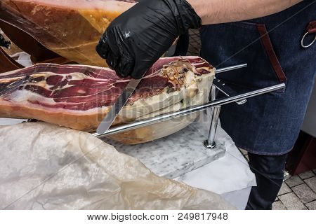 Prosciutto. Traditional Spanish Ham On Close Up. Slicing Hamon Iberic. Waiter Is Slicing Jamon Prosc