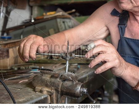 Close Up View On Process Of Screw Thread Turning. Screw Cutting In Progress. Older Man Working At Th