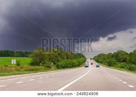 Asphalt Highway Road And Rainy Clody Dark Thunder Sky On Background. Bad Stormy Weather Forecast. Wa