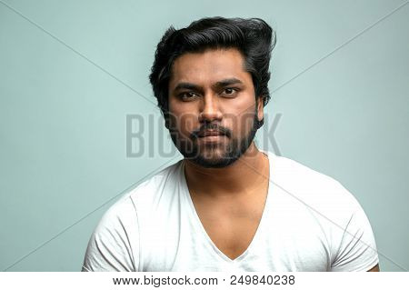 Close Up Portrait Of Attractive Indian Man With Serious Face Concentrated On His Job. Gorgeous Hindo