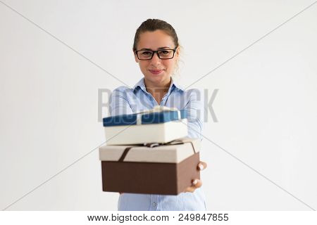 Happy Company Representative Offering Gifts To Customers. Content Smiling Caucasian Woman Giving Pre