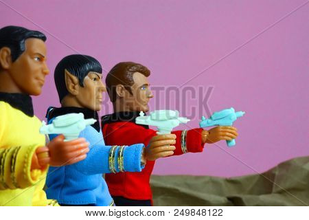 JULY 14 2018: Recreation of a scene from Star Trek The Original Series where Captain Kirk, Mr Spock and Lte Leslie, red shirt security, draw phasers after beaming down to a planet - Mego style figures