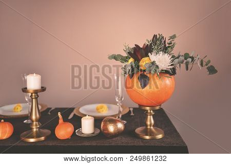 Beautiful Autumn Wedding Decor Floral Bouquet In A Pumpkin Vase. Preparing For Halloween. Table Sett