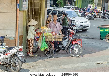 Ho Chi Minh City, Vietnam - 4 April, 2018: Street Scene - Traditional Saleswoman With Her Bike Fully