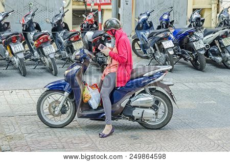 Ho Chi Minh City, Vietnam - 4 April, 2018: Typical Street Scene -  Young Woman On Her Moped Fully Pr
