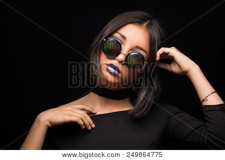 Portrait Of Cool Crazy Brunette Fashionable Girl In Sunglasses, Casual Hairdo On Black Background. W