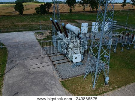 High Voltage Energy Transformer Station In Forest, Aerial View.