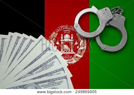 Afghanistan Flag With Handcuffs And A Bundle Of Dollars. The Concept Of Illegal Banking Operations I